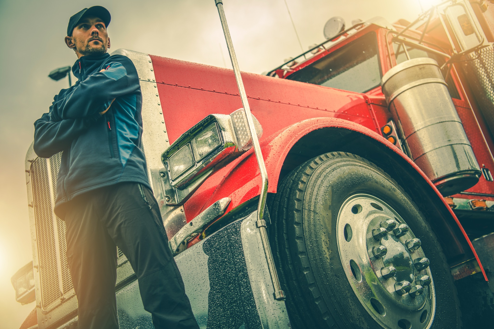 Driver beside a red tractor-trailer